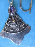Full view of pendant showing stone, beadwork, and gold accent