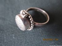 side view of sterling poison ring showing hinged bezel and bead border