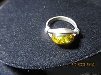 Top view of sterling ring showing amber-colored stone