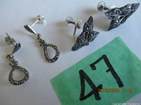 Both earring pairs laid out with lot number