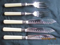 Set of five utensils laid out showing full form