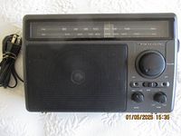 Front view showing speaker grille and tuning scale