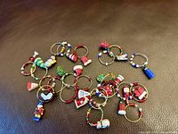 Group view of all wine glass charms spread on dark surface