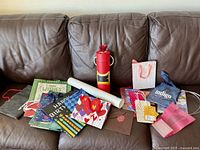 all items spread on sofa showing variety of bags, tube, roll