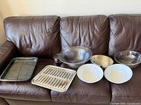 All nine kitchenware items arranged on sofa