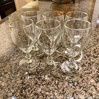 Six Libbey Georgian clear glass goblets grouped on countertop
