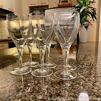 Front view of all six crystal wine glasses on countertop