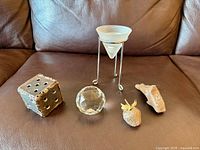 All five decorative items lined on brown leather background
