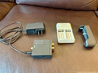 Front view of all four electronic items on brown surface