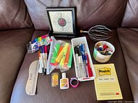 Overall view of all office supplies on couch