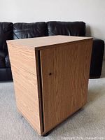Front and side view of cabinet showing woodgrain finish and lock