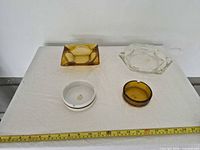 Group view of four ashtrays on table