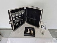 Open view of travel bar case, shaker and boot measures