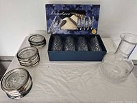 All items grouped: boxed tumblers, coaster stacks, decanter