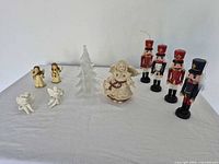 Group shot showing all items: two candle angels, two musical angels, frosted glass tree, winter angel statue, four nutcrackers