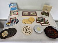 Overall view of assorted coaster sets and singles on table