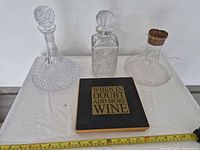 all three decanters with stoppers and hot pad shown together