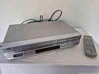 Front view of JVC DVD/VHS combo with remote on top