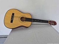 Front view of 3/4 classical guitar on table