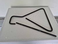 Triangle dinner bell and striker rod laid flat