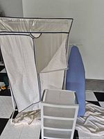 Ironing board, portable wardrobe with zippered cover, plastic shelf