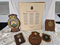 Group shot of poem print and five naval plaques