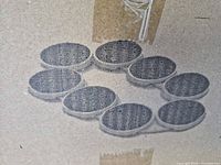 halftone image on box showing eight round trays arranged in a circle