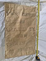 Full view of mailbag showing stencilled text and tape for length