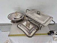 All three serving dishes with lids shown together on table