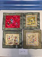 Group shot of four embroidered silk panels