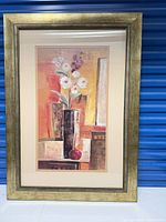 Full view of framed print against blue backdrop
