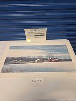 Full view of lithograph with certificate of authenticity displayed