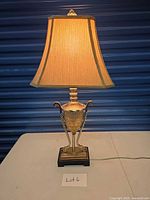 Full view of table lamp with shade illuminated on table