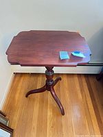 Full view of tilt-top mahogany tripod table showing top, pedestal and legs