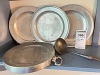 Front view showing three plates, serving tray and ladle