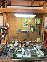 Overall workbench view with majority of hand tools visible on pegboard and benchtop