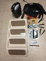 All items laid out: pet stairs, shredder, harness, swim mask, hand grips, resistance cord, grooming tools