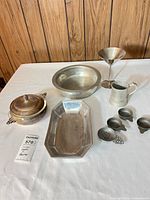 Group overview of all nine silver-tone pieces on table