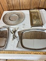 Group view showing all trays, platter, spoons with ruler for scale