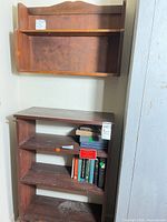 Freestanding bookshelf and wall shelf together in corner