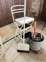 Overall lot showing step stool, mop bucket with wringer, dustpan, broom and cleaning handle