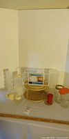 Group view showing turntable, lid rack, plastic containers, jars, measuring cup and lids