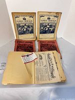 Overall lot showing two Family Herald, two Family Journal, newspaper pages in manila folder and small flag