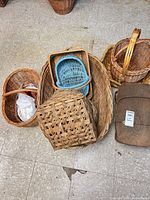 Group shot showing majority of baskets including large hamper, picnic basket, blue tray, open lattice basket, rectangular and oval baskets