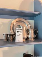Group showing charger plate, pitcher, tankard and two small beakers