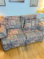 Front view of loveseat with cushions and pillows
