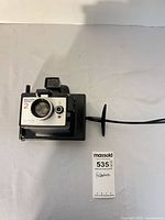 Front view of Polaroid Square Shooter 2 camera on stand