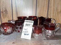 Group view of all ruby flashed glass pieces on shelf