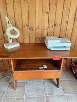 Full view of wooden table with objects on top