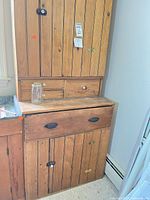 Front view showing full hutch with upper cabinet, two small drawers, large drawer, lower cabinet
